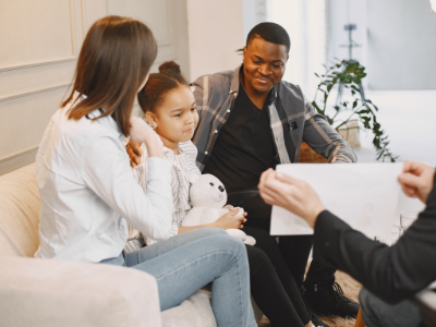 a family sitting on a couch in a therapy session
